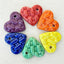 Set of colorful heart-shaped objects on a wooden surface