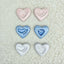 Set of heart-shaped ceramics with hand and footprints on a  lace background