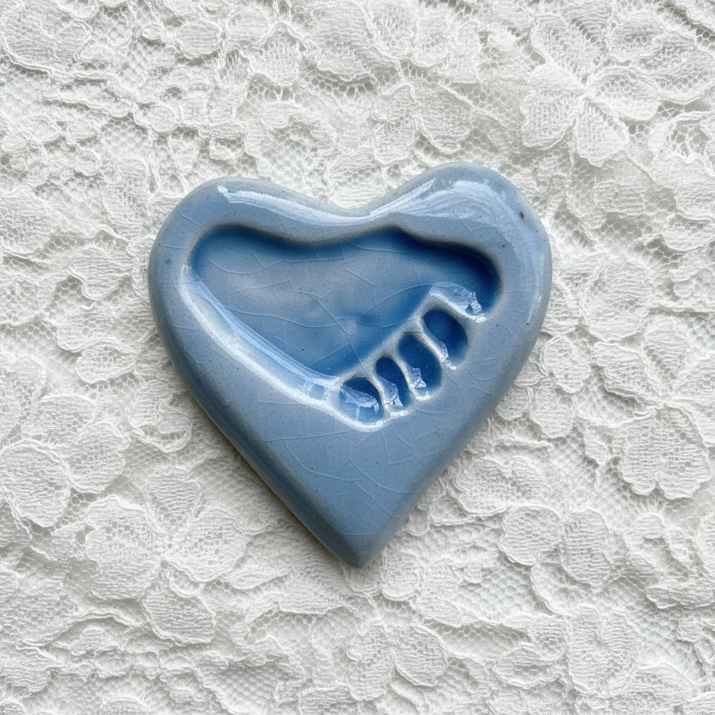Light blue ceramic heart with a footprint in the center