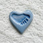 Light blue ceramic heart with a footprint in the center