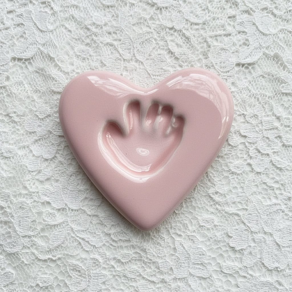 Heart-shaped pink ceramic with a handprint