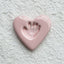 Heart-shaped pink ceramic with a handprint