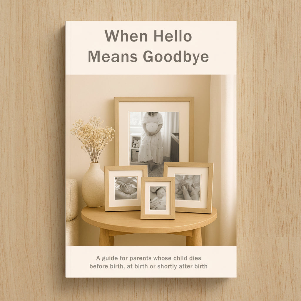 A soft beige book cover with the title 'When Hello Means Goodbye' above a styled interior scene showing four light wood picture frames on a round wooden table. Text at the bottom reads, 'A guide for parents whose child dies before birth, at birth or shortly after birth.