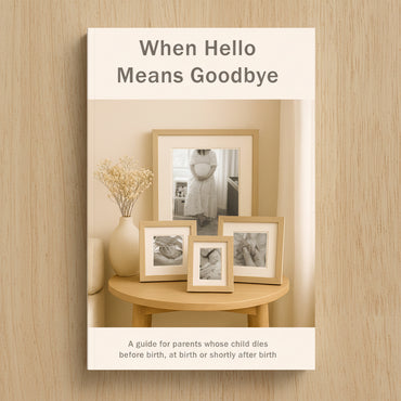 A soft beige book cover with the title 'When Hello Means Goodbye' above a styled interior scene showing four light wood picture frames on a round wooden table. Text at the bottom reads, 'A guide for parents whose child dies before birth, at birth or shortly after birth.