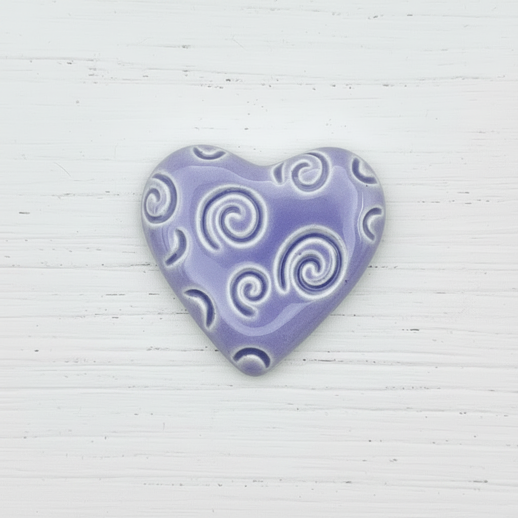 Heart-shaped object with spiral patterns on a white background
