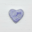 Heart-shaped object with spiral patterns on a white background